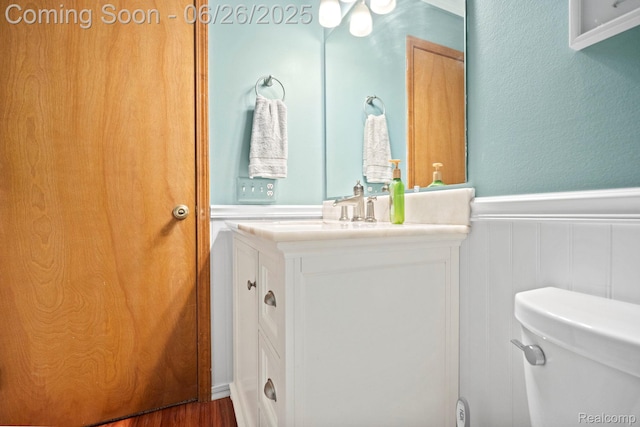 4386 Kelly Circle Dr, Commerce Twp, MI 48390 - half bath featuring wainscoting, vanity, a decorative wall, and wood finished floors