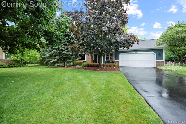 4386 Kelly Circle Dr, Commerce Twp, MI 48390 - obstructed view of property with asphalt driveway, brick siding, a garage, and a front lawn