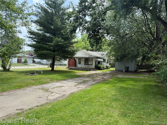 21738 Evergreen St, Saint Clair Shores, MI 48082 - view of front of home featuring a storage unit, driveway, and a chimney