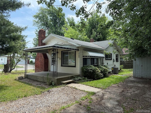 21738 Evergreen St, Saint Clair Shores, MI 48082 - view of front facade with covered porch and a chimney