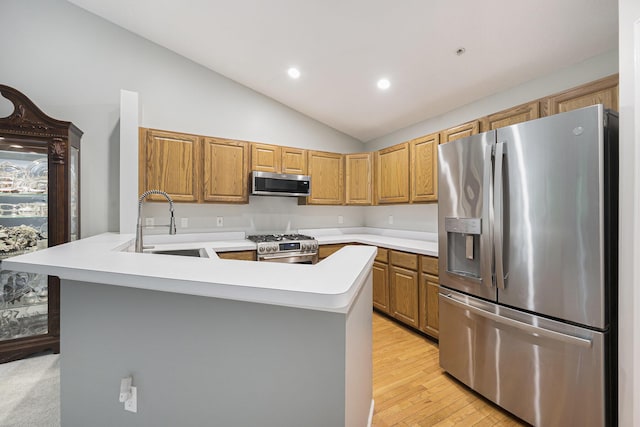 4219 Inverness St Unit 118, Dexter, MI 48130 - kitchen with stainless steel appliances, lofted ceiling, light countertops, a peninsula, and light wood-style flooring