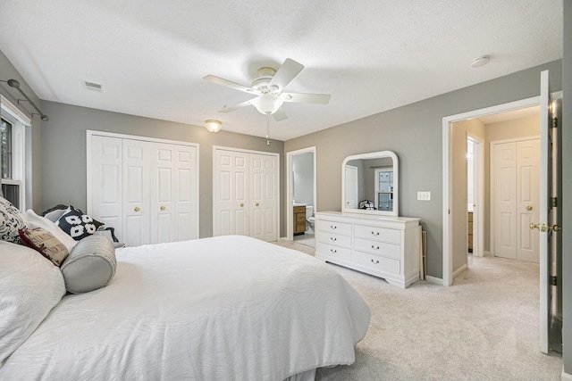 4219 Inverness St Unit 118, Dexter, MI 48130 - bedroom featuring two closets, light carpet, and a ceiling fan