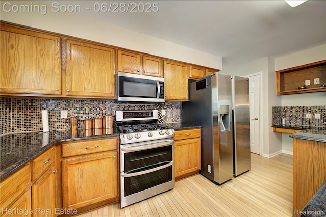 3400 Yosemite Dr, Lake Orion, MI 48360 - kitchen with appliances with stainless steel finishes, decorative backsplash, light wood finished floors, and brown cabinets