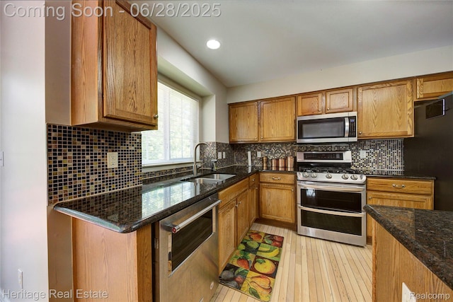 3400 Yosemite Dr, Lake Orion, MI 48360 - kitchen featuring stainless steel appliances, brown cabinets, dark stone countertops, and tasteful backsplash