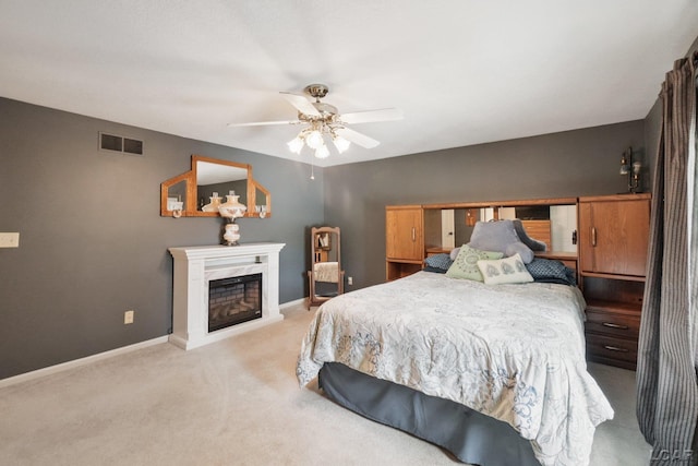 221 Burt St, Tecumseh, MI 49286 - carpeted bedroom featuring a glass covered fireplace and ceiling fan