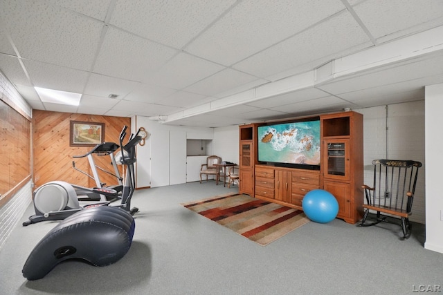 221 Burt St, Tecumseh, MI 49286 - workout room featuring a paneled ceiling, wooden walls, and carpet floors