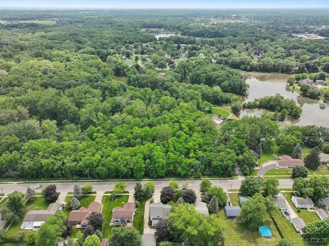 221 Burt St, Tecumseh, MI 49286 - aerial perspective of suburban area featuring a forest and a large body of water