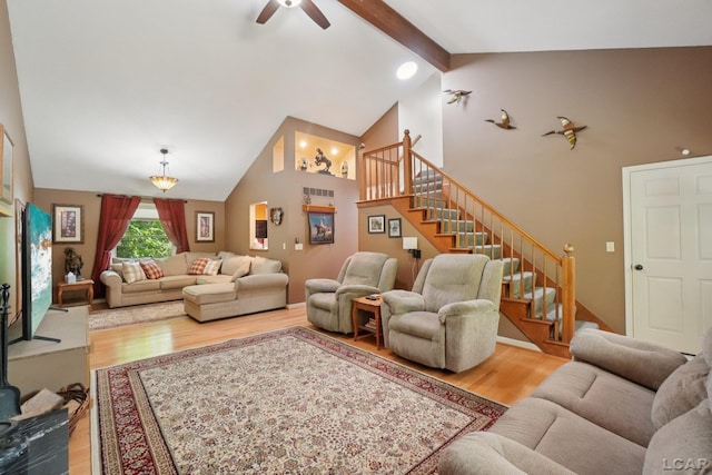 221 Burt St, Tecumseh, MI 49286 - living area featuring light wood-type flooring, stairs, ceiling fan, beam ceiling, and high vaulted ceiling