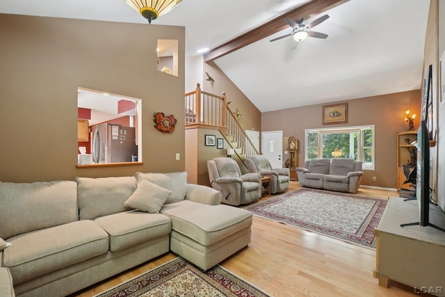 221 Burt St, Tecumseh, MI 49286 - living room with light wood-style floors, stairway, beam ceiling, high vaulted ceiling, and ceiling fan
