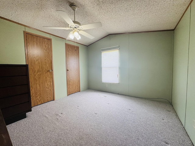 8836 Stevensville Baroda Rd Lot 135, Baroda, MI 49101 - unfurnished bedroom with carpet floors, vaulted ceiling, a textured ceiling, crown molding, and two closets