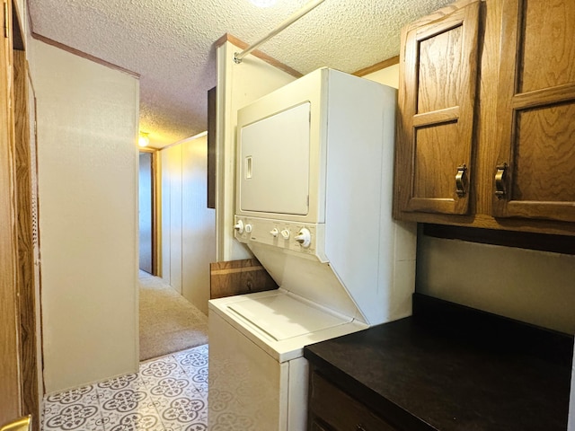 8836 Stevensville Baroda Rd Lot 135, Baroda, MI 49101 - laundry area with stacked washer / dryer, a textured ceiling, and light tile patterned floors