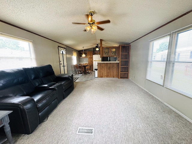 8836 Stevensville Baroda Rd Lot 135, Baroda, MI 49101 - living area with a ceiling fan, vaulted ceiling, ornamental molding, plenty of natural light, and light carpet