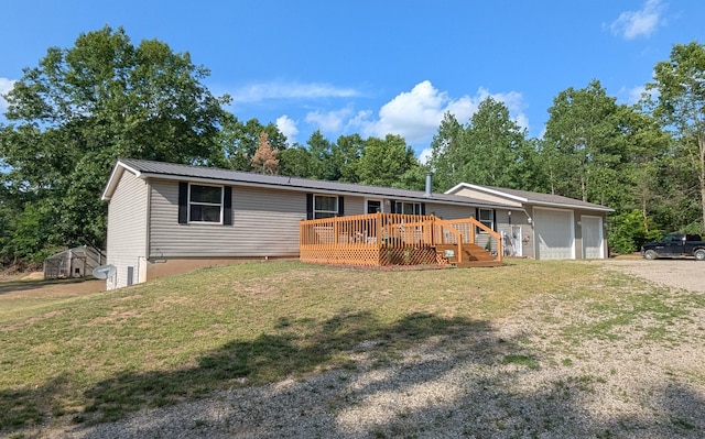 17122 Kent Ave, Morley, MI 49336 - manufactured / mobile home featuring a wooden deck, a front yard, driveway, and a garage