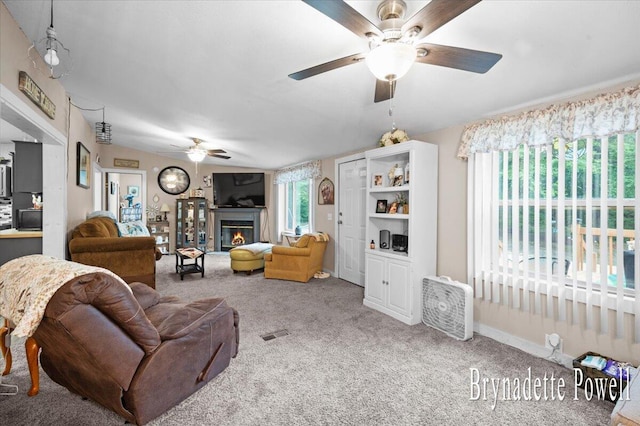 17122 Kent Ave, Morley, MI 49336 - carpeted living room with a ceiling fan and a glass covered fireplace