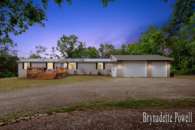 17122 Kent Ave, Morley, MI 49336 - view of front of home with driveway, a deck, and an attached garage