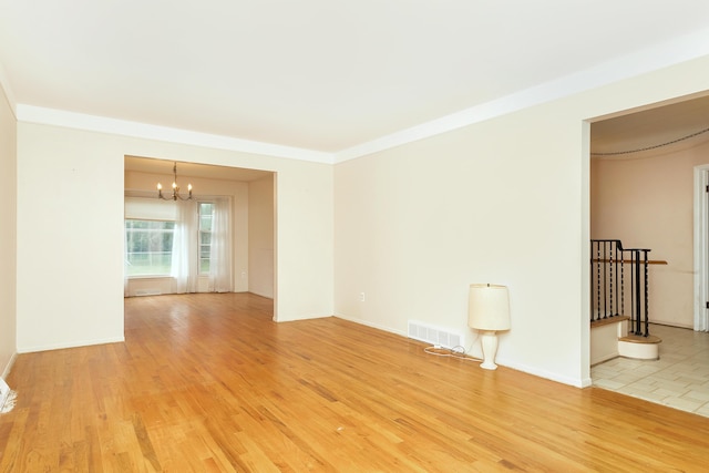 18210 Rainbow Dr, Lathrup Village, MI 48076 - empty room featuring a chandelier and light wood-type flooring