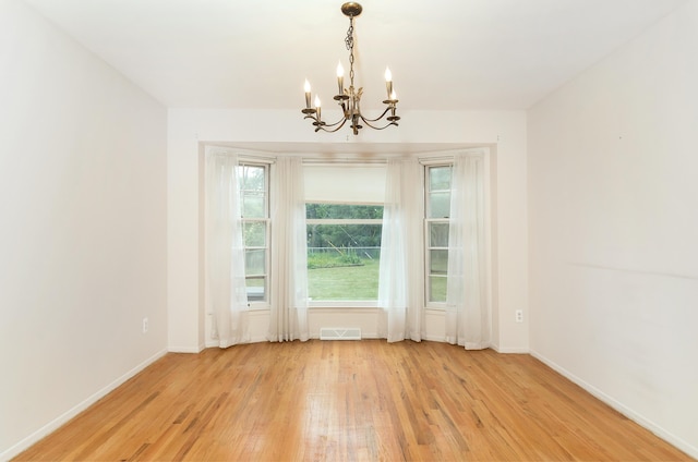 18210 Rainbow Dr, Lathrup Village, MI 48076 - unfurnished room featuring a chandelier and light wood-type flooring