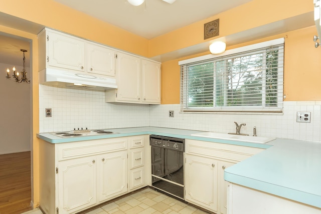 18210 Rainbow Dr, Lathrup Village, MI 48076 - kitchen with dishwasher, under cabinet range hood, a chandelier, and healthy amount of natural light