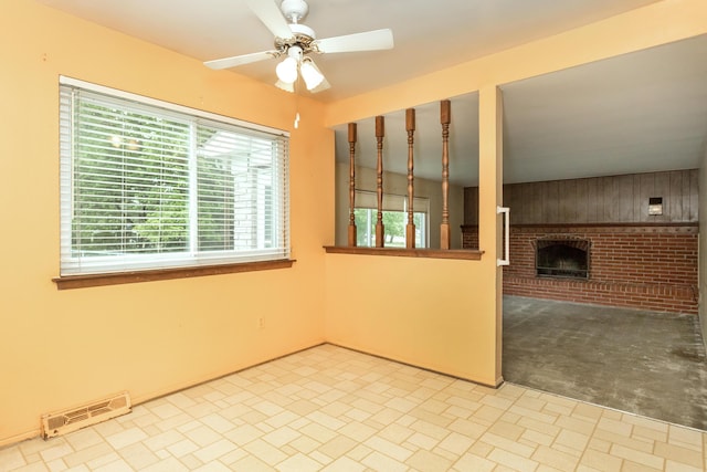 18210 Rainbow Dr, Lathrup Village, MI 48076 - spare room with a ceiling fan and a brick fireplace