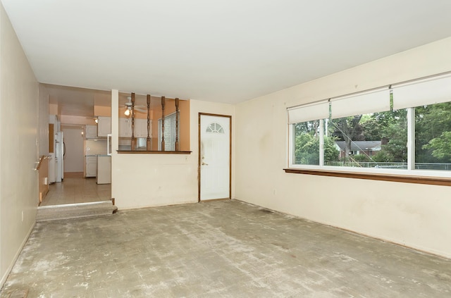 18210 Rainbow Dr, Lathrup Village, MI 48076 - unfurnished living room with ceiling fan and concrete flooring