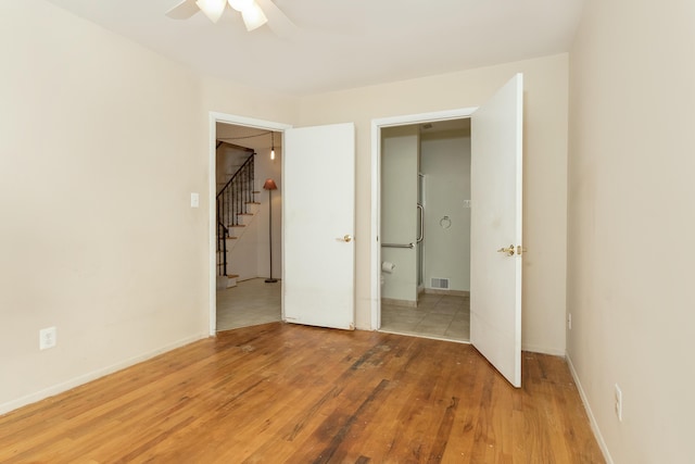 18210 Rainbow Dr, Lathrup Village, MI 48076 - unfurnished bedroom featuring wood finished floors and a ceiling fan