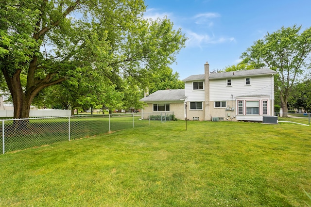 18210 Rainbow Dr, Lathrup Village, MI 48076 - rear view of property with a chimney and brick siding