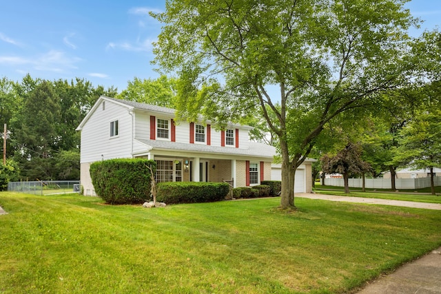 18210 Rainbow Dr, Lathrup Village, MI 48076 - traditional-style home featuring concrete driveway, brick siding, a garage, and covered porch