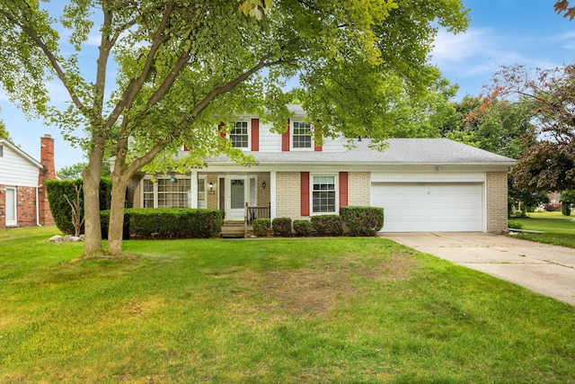 18210 Rainbow Dr, Lathrup Village, MI 48076 - view of front of house with a garage, driveway, brick siding, and a front yard