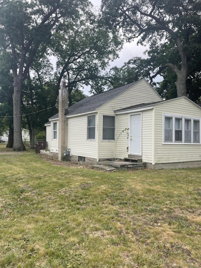 1111 S Quarterline Rd, Muskegon, MI 49442 - view of front of property with a front yard and a chimney