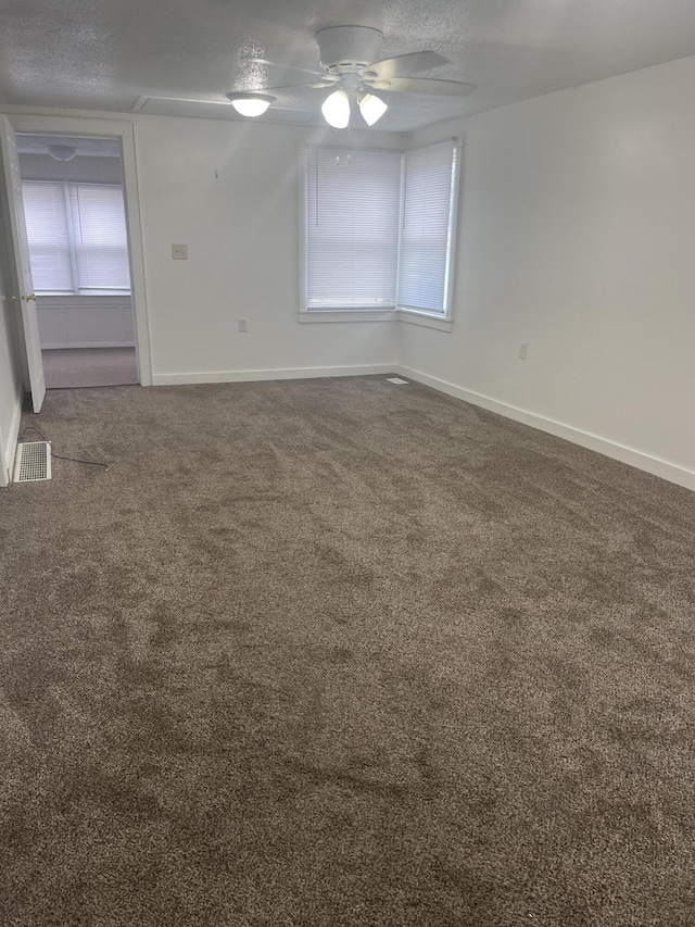 1111 S Quarterline Rd, Muskegon, MI 49442 - spare room with carpet flooring, a ceiling fan, and a textured ceiling