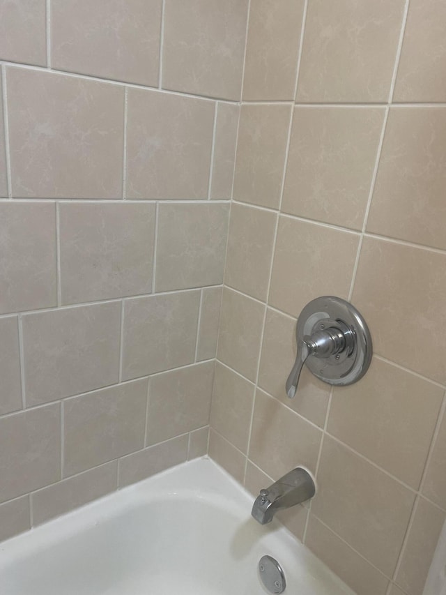 1111 S Quarterline Rd, Muskegon, MI 49442 - full bathroom featuring bathing tub / shower combination