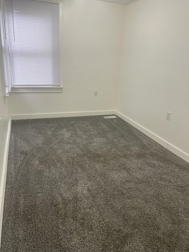1111 S Quarterline Rd, Muskegon, MI 49442 - carpeted empty room featuring baseboards