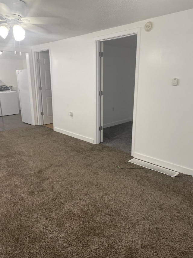 1111 S Quarterline Rd, Muskegon, MI 49442 - unfurnished room with a ceiling fan, washer / dryer, dark carpet, and a smoke detector