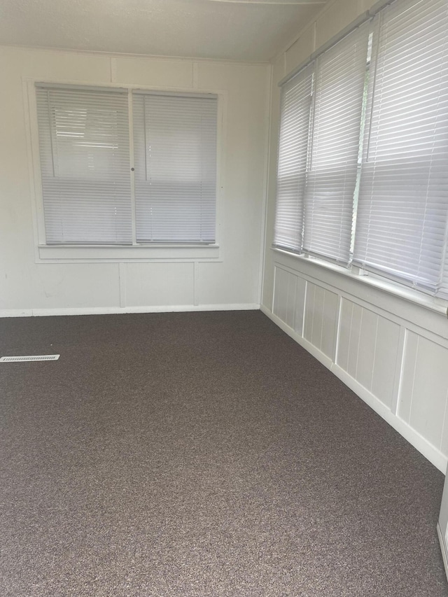 1111 S Quarterline Rd, Muskegon, MI 49442 - spare room featuring dark carpet