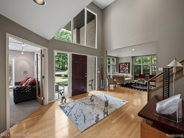 6224 Bromley Ct, West Bloomfield, MI 48322 - foyer entrance featuring plenty of natural light, a towering ceiling, and wood finished floors