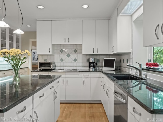 6224 Bromley Ct, West Bloomfield, MI 48322 - kitchen with stainless steel dishwasher, white cabinetry, cooktop, light wood-style flooring, and decorative backsplash