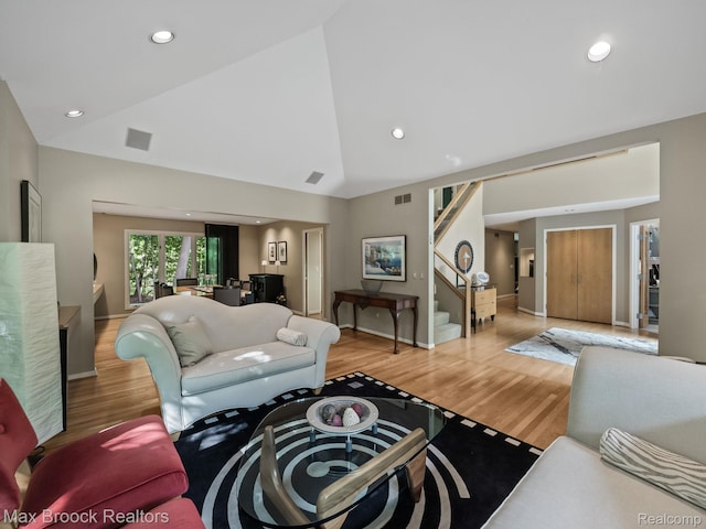 6224 Bromley Ct, West Bloomfield, MI 48322 - living area with stairway, light wood finished floors, high vaulted ceiling, and recessed lighting