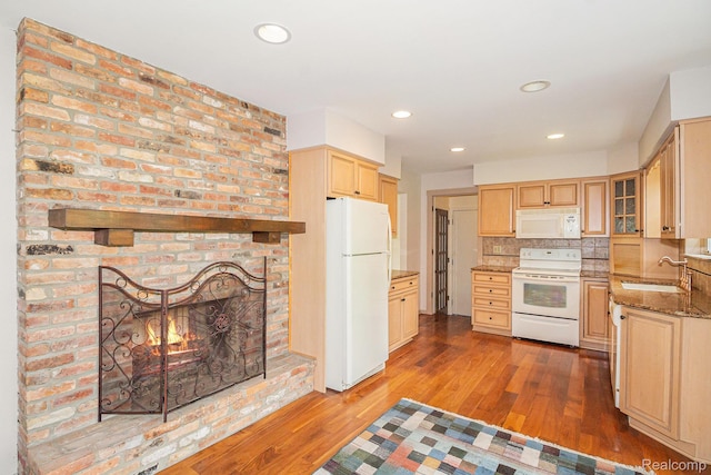 6392 Mckenzie Dr, Flint, MI 48507 - kitchen featuring white appliances, wood finished floors, light brown cabinetry, stone countertops, and decorative backsplash