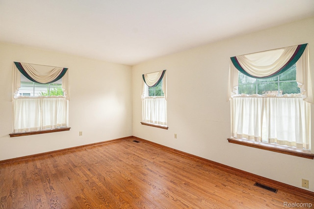 6392 Mckenzie Dr, Flint, MI 48507 - spare room featuring plenty of natural light and wood finished floors