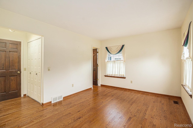 6392 Mckenzie Dr, Flint, MI 48507 - spare room featuring wood finished floors and baseboards