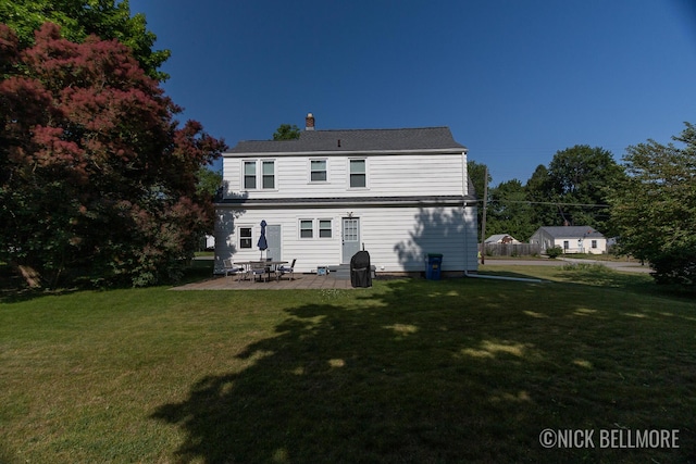 2036 Dawson Ave NE, Grand Rapids, MI 49505 - back of property with a yard, a patio area, and a chimney