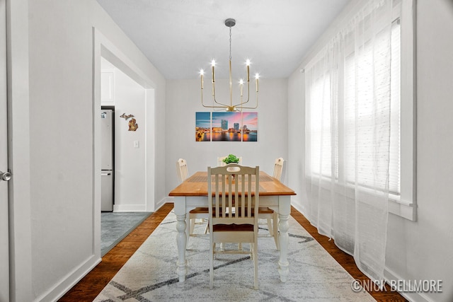 2036 Dawson Ave NE, Grand Rapids, MI 49505 - dining space featuring a chandelier and dark wood-style flooring