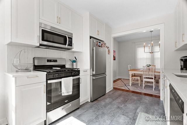 2036 Dawson Ave NE, Grand Rapids, MI 49505 - kitchen featuring stainless steel appliances, light countertops, white cabinetry, and backsplash