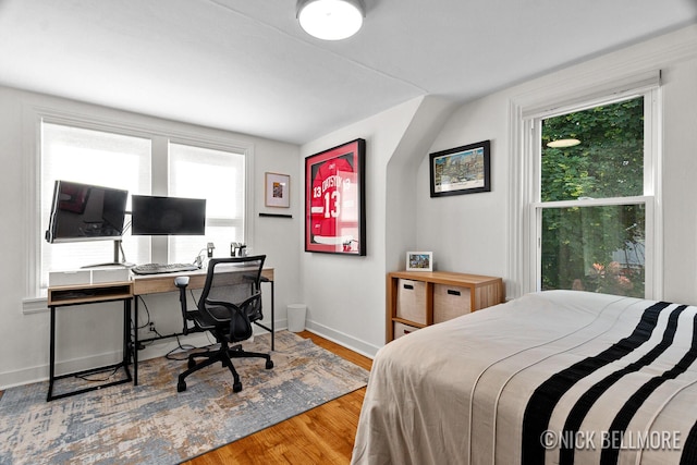 2036 Dawson Ave NE, Grand Rapids, MI 49505 - bedroom with multiple windows, wood finished floors, and an office area