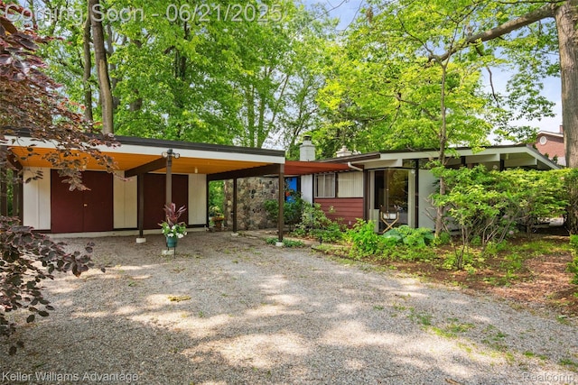 5959 Rosetta St, Dearborn Heights, MI 48127 - mid-century inspired home with a chimney, a carport, and gravel driveway