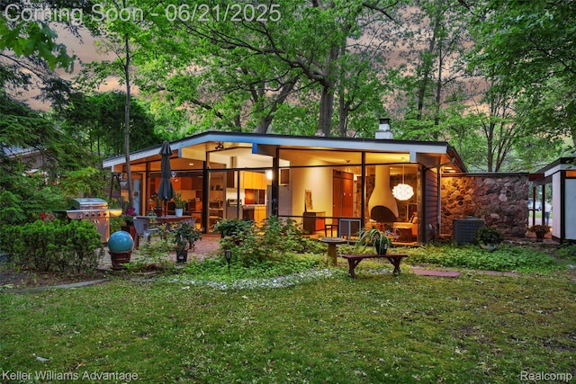 5959 Rosetta St, Dearborn Heights, MI 48127 - outdoor structure at dusk with a lawn