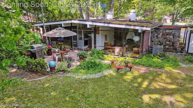 5959 Rosetta St, Dearborn Heights, MI 48127 - back of property featuring a patio, a yard, and a chimney