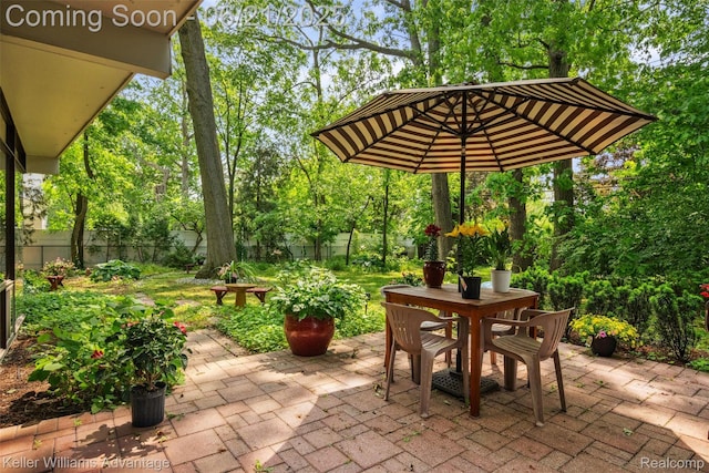 5959 Rosetta St, Dearborn Heights, MI 48127 - fenced backyard with a patio area, outdoor dining area, and view of scattered trees