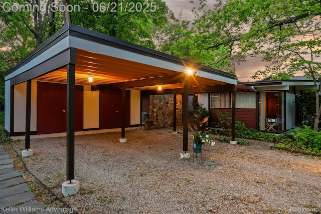 5959 Rosetta St, Dearborn Heights, MI 48127 - back of house at dusk featuring a carport