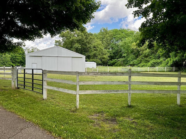9910 8 Mile Rd, Ceresco, MI 49033 - view of yard featuring a pole building, an outdoor structure, a detached garage, and a view of rural / pastoral area